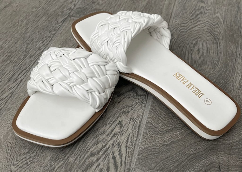 white braided sandals on gray wood floor