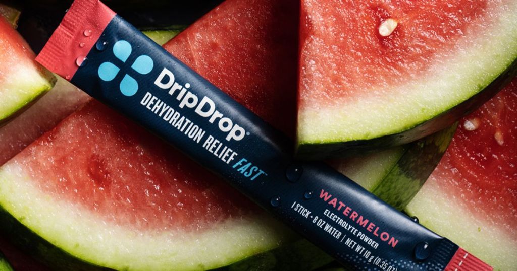 A stick of DripDrop Watermelon Hydration mix on a bunch of watermelon slices