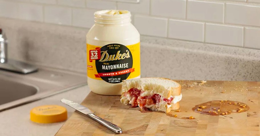dukes mayo jar with sandwich on cutting board