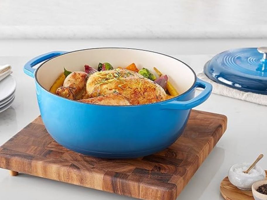 blue dutch oven on cutting board