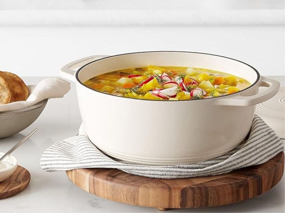 white dutch oven pot on cutting board