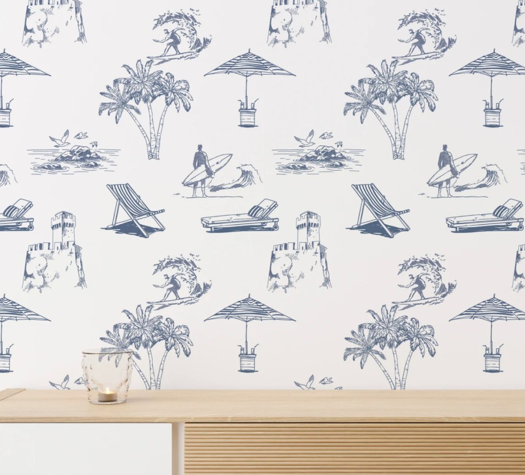 blue and white wallpaper with wood console table below it