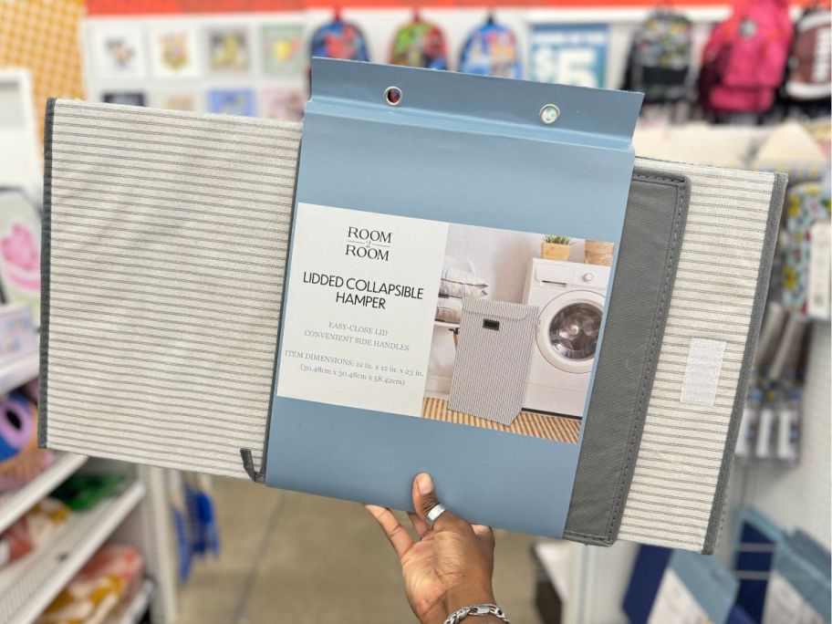 Lidded Collapsible Hamper package being held by hand in store