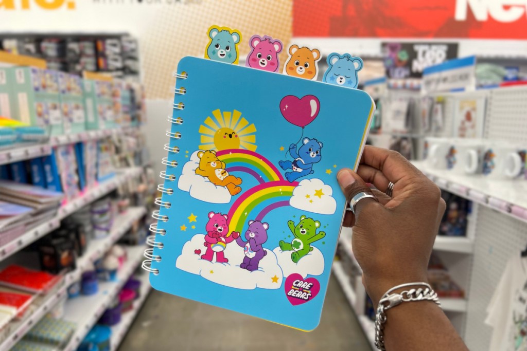 hand holding care bears notebook in store