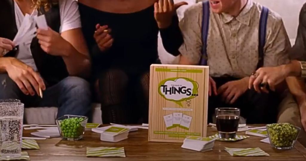 game of things on a coffee table with lots of people gathered around playing