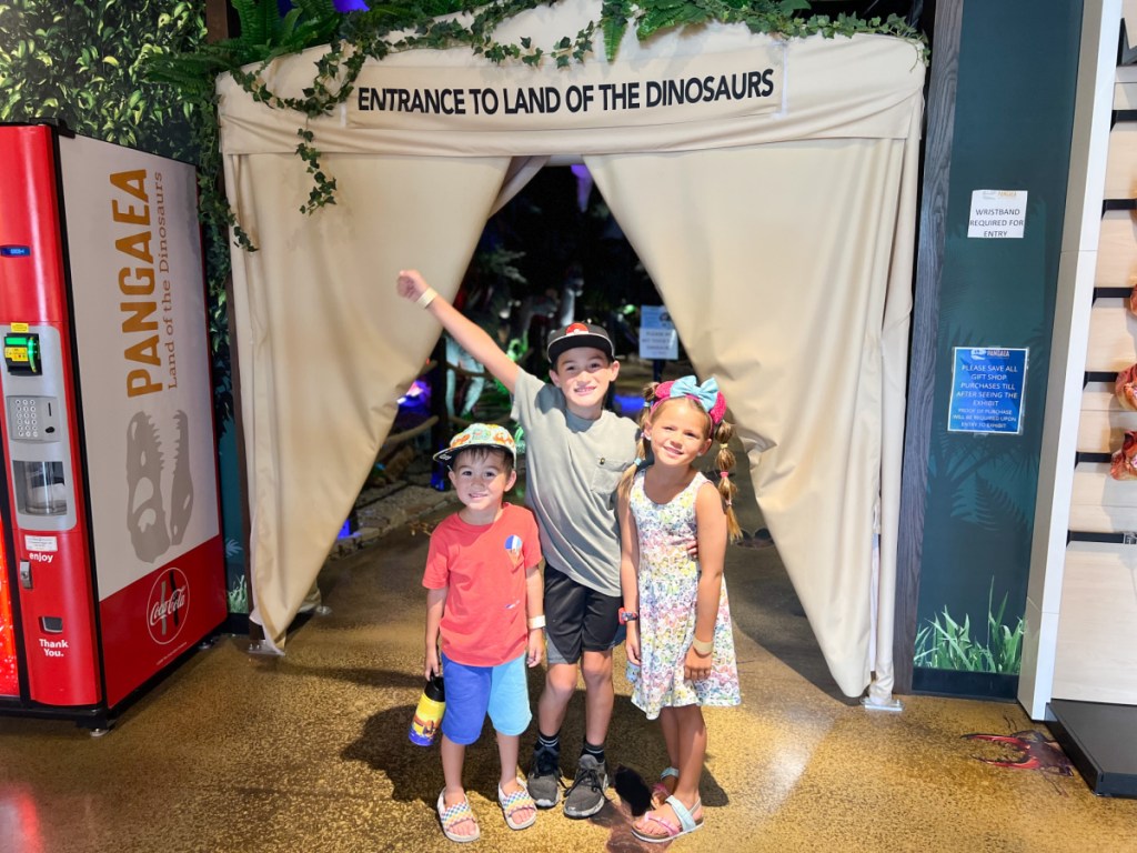 three kids standing at entrance of pangaea
