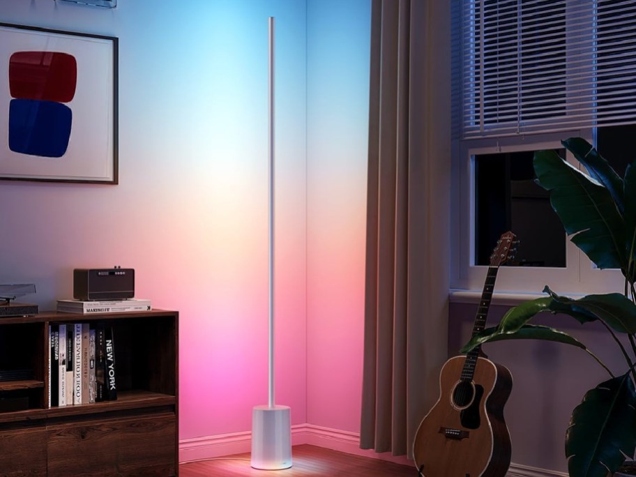 govee LED floor lamp in the corner of a bedroom