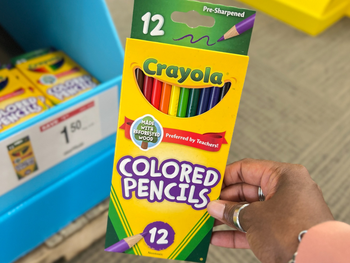 hand holding Crayola Colored Pencils, 12-Pack in front of display
