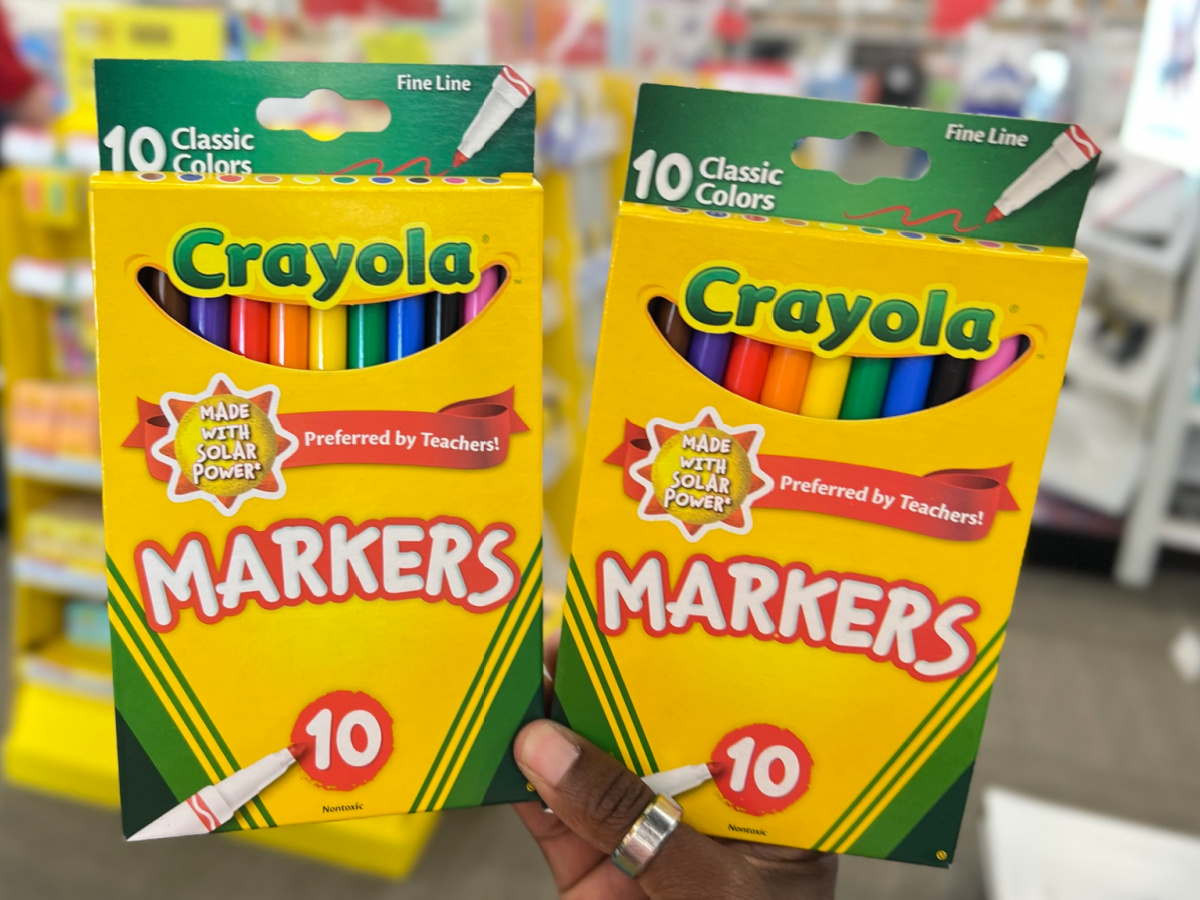 hand holding two packs of Crayola Fine Line Markers Assorted Classic Colors, 10-Pack
