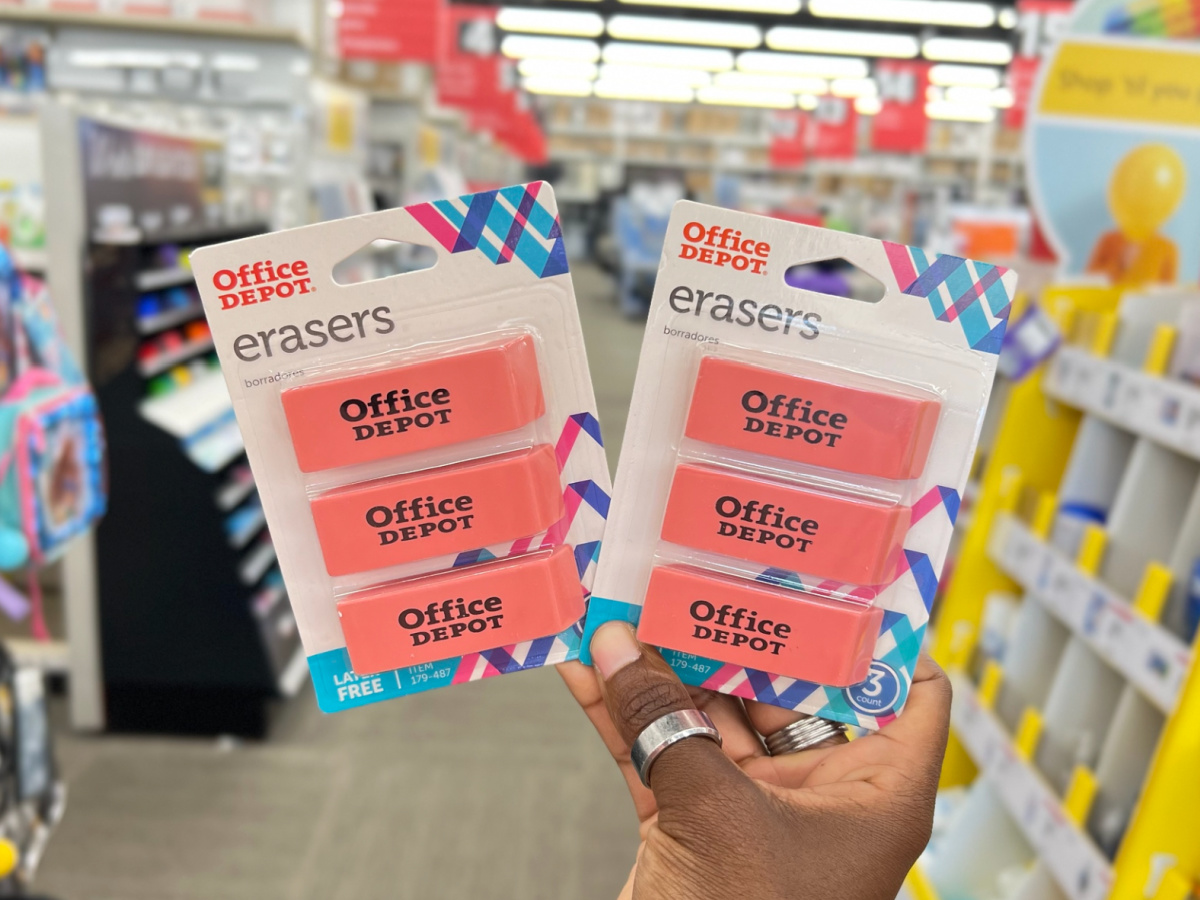hand holding two packs of Office Depot Brand Large Beveled Erasers 3-Pack on display