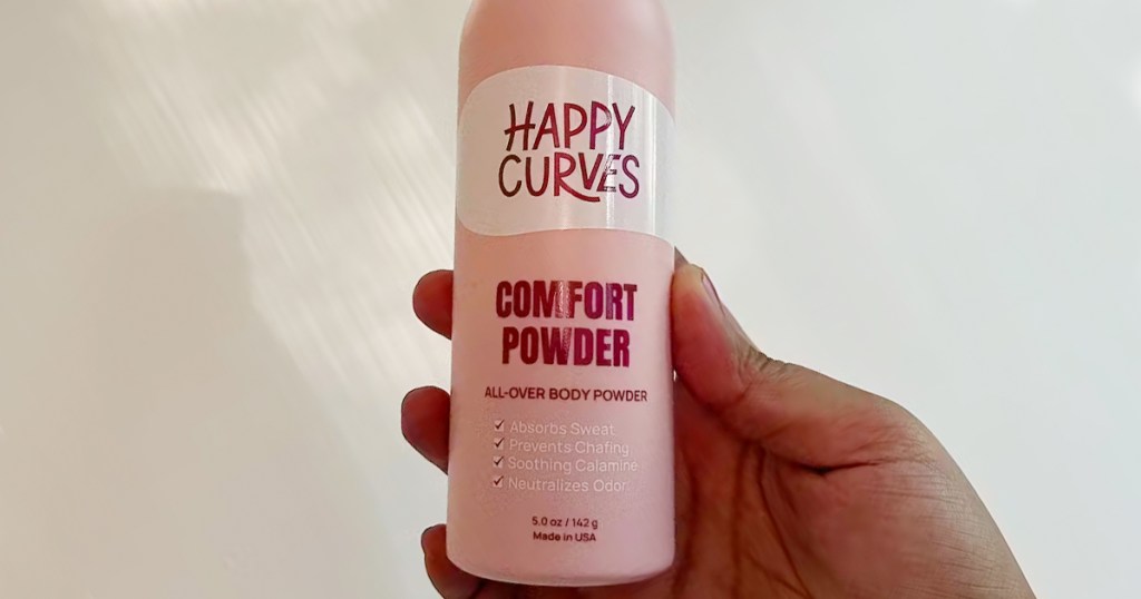 hand holding happy curves body powder