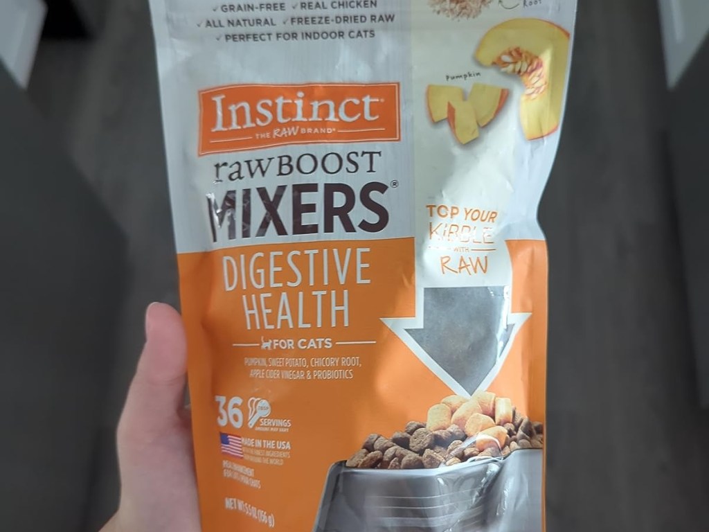 holding a bag of cat food mixers