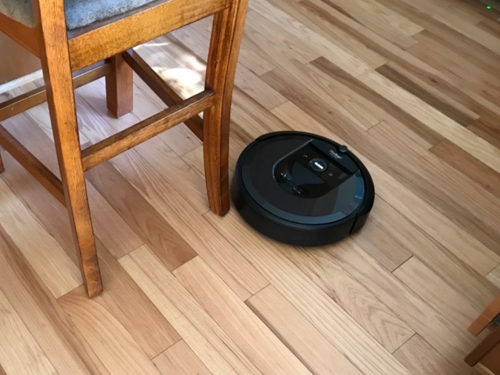 robot vacuum running on a wooden floor