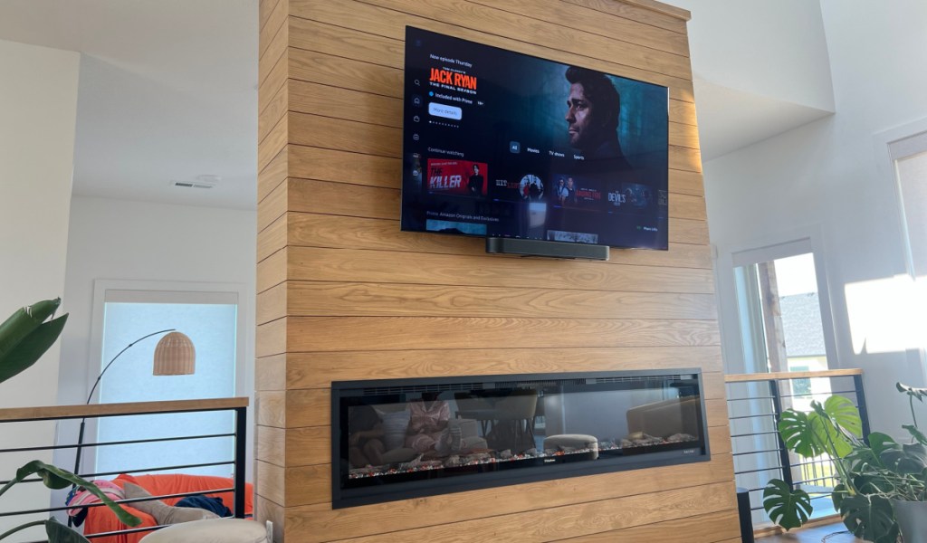 amazon prime streaming jack ryan series on a tv screen mounted on a fireplace wall