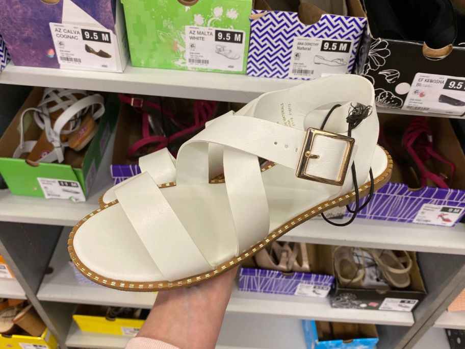 arm holding women's sandals in store