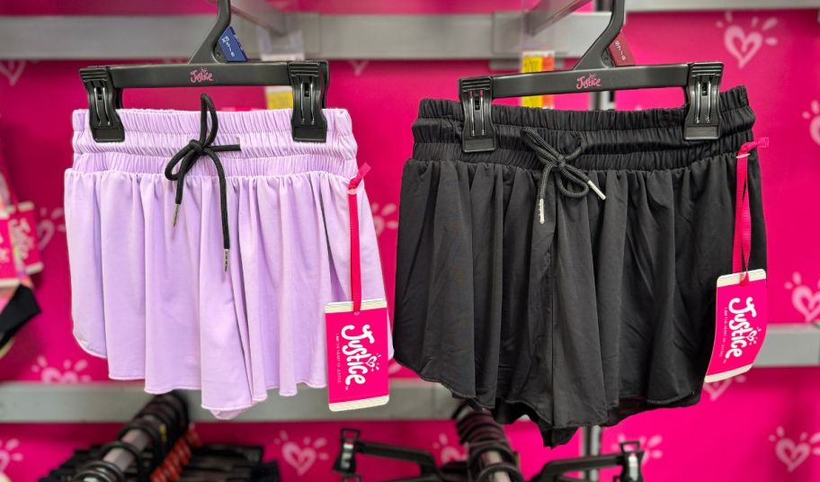 two pair of justice girls flutter shorts hanging on racks in a walmart store