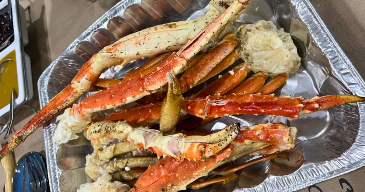 a foil pan filled with steamed king crab legs