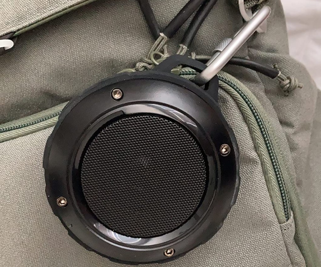 mini speaker hanging on backpack