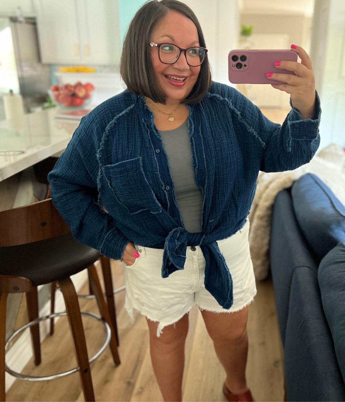 a woman wearing a pair of white aerie daydream shorts taking a selfie
