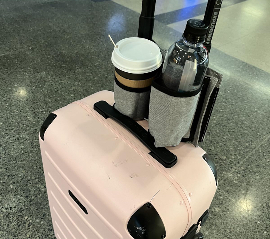 gray cup holder on pink suitcase 
