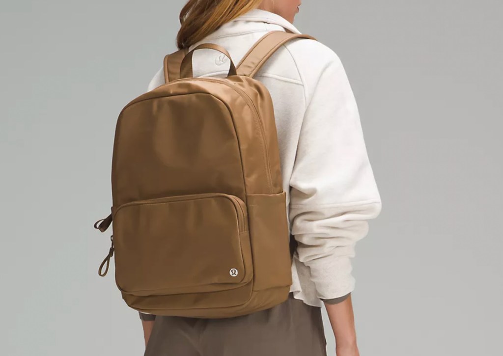 brown backpack on womans back
