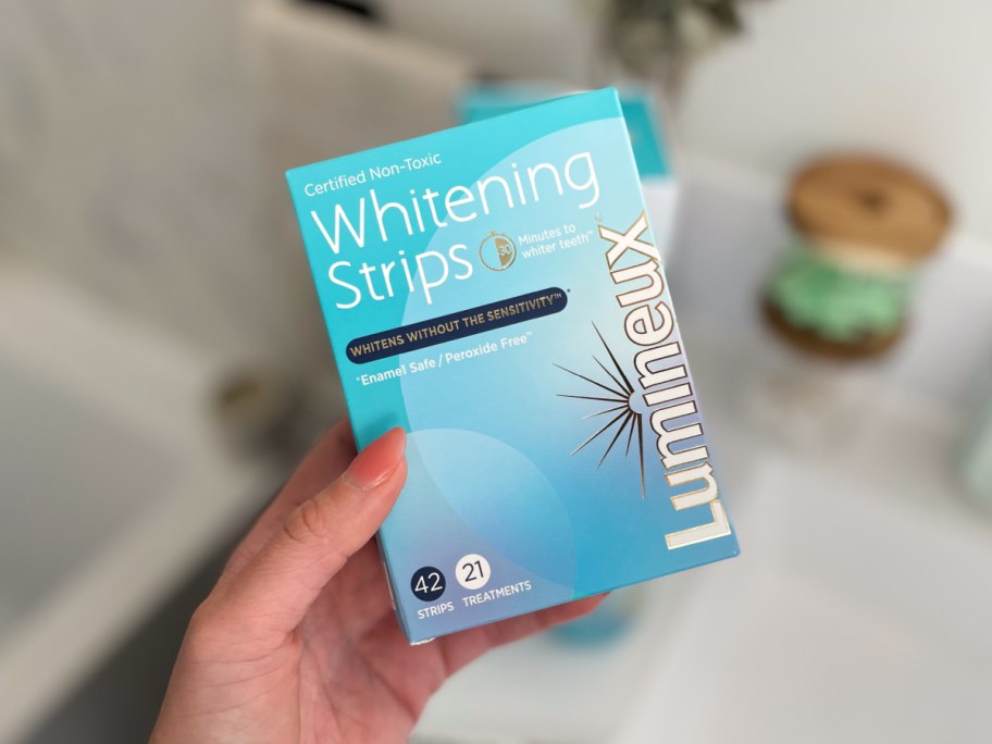 hand holding box of whitening strips
