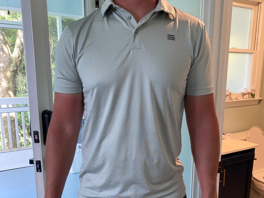 man wearing polo shirt inside of his hosue