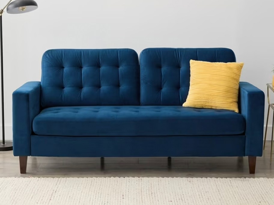dark blue couch with yellow pillow in living room 