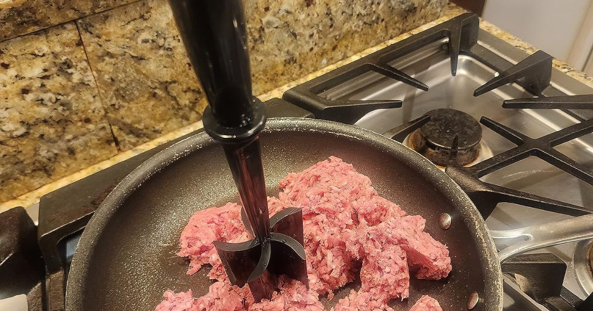 person using meat chopper