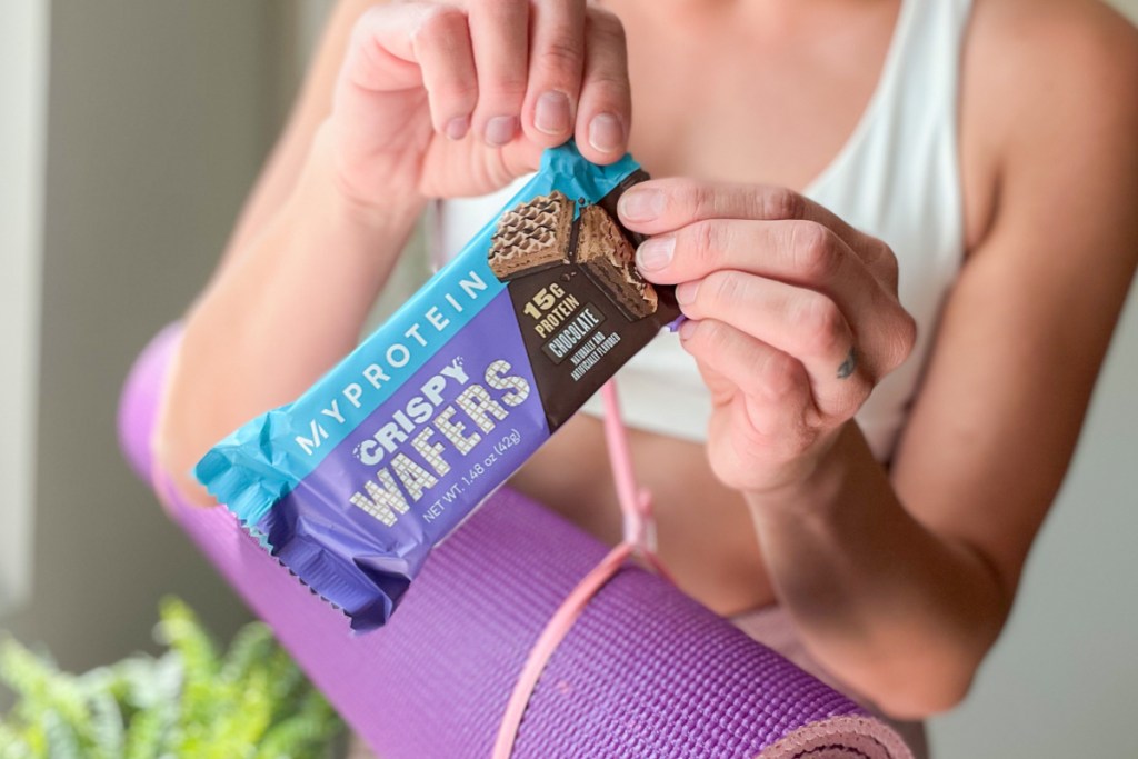 hands opening protein wafer bar