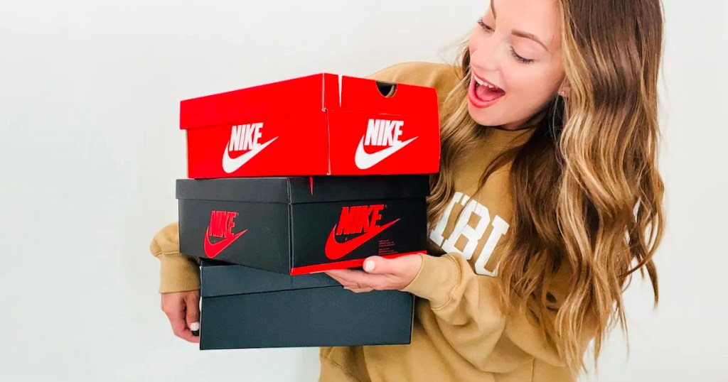 woman holding nike boxes