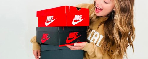 woman holding nike boxes