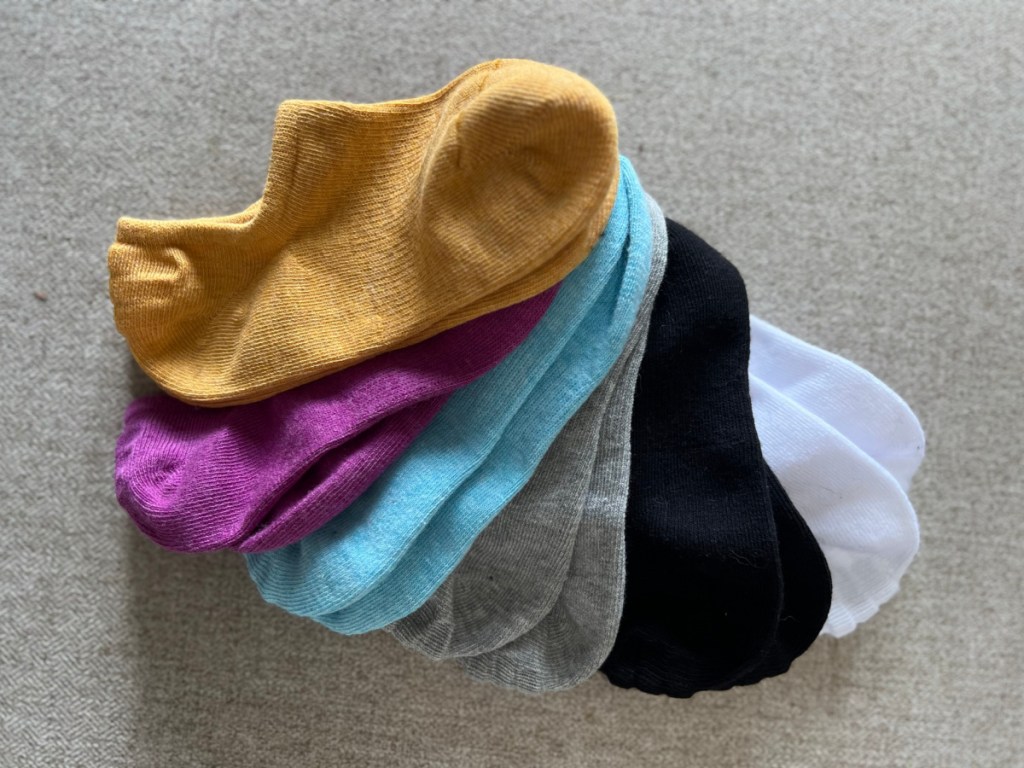 six pairs of colorful no show socks in a pile