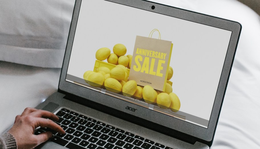 hand typing on laptop with nordstrom anniversary sale on screen