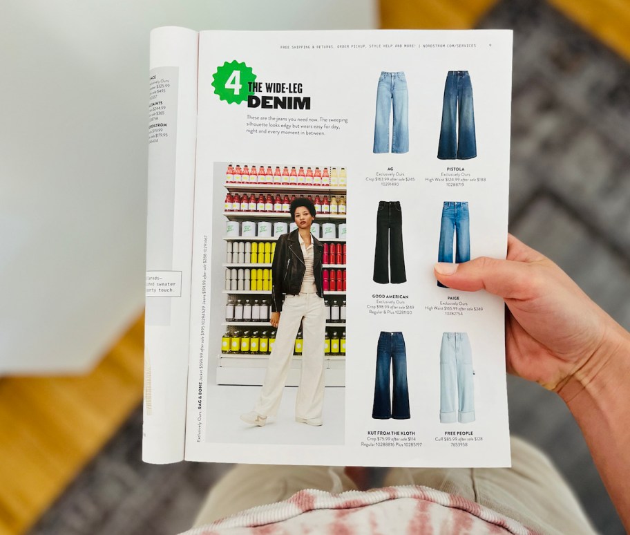 hand holding magazine open on the wide leg denim page