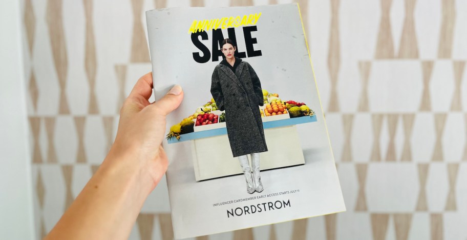 hand holding a nordstrom anniversary sale magazine
