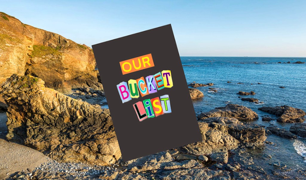 our bucket list book with rocky cliff beach in background