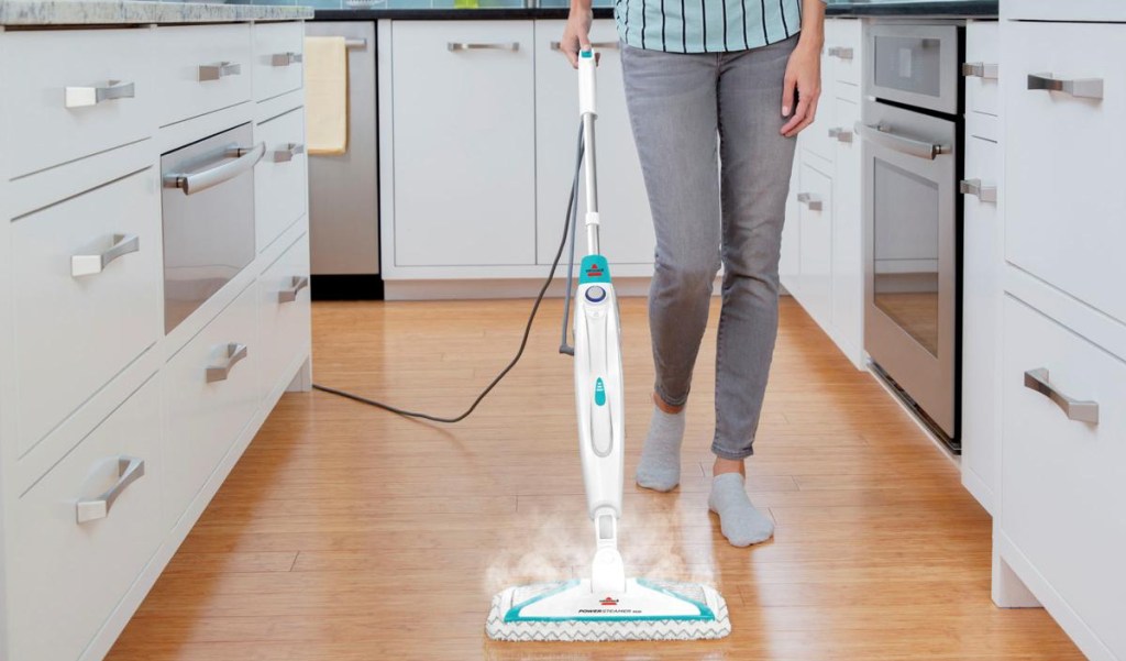 person steam mopping their home with the BISSELL 2-in-1 portable steam mopperson steam mopping their home with the BISSELL 2-in-1 portable steam mop