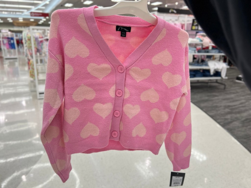 pink heart cardigan from Target in woman's hand