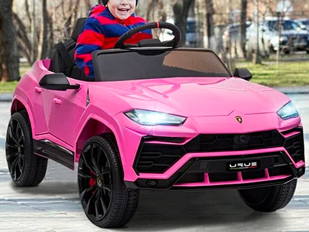 kid riding in pink lamborghini ride on car