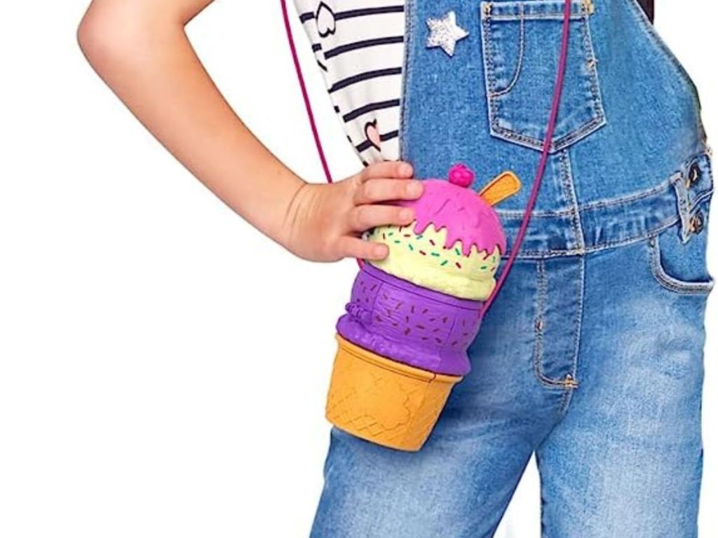 girl wearing Polly Pocket 2-In-1 Travel toy in shape of an ice cream cone