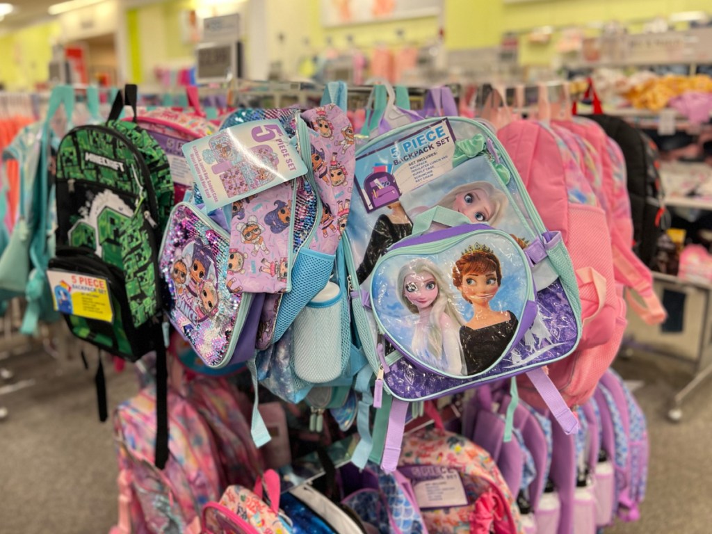 rack filled with kids character backpacks