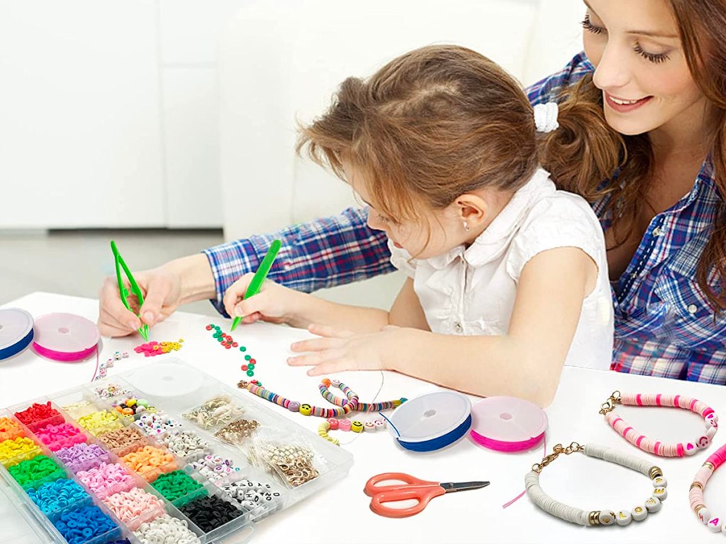 woman and child making bracelets 
