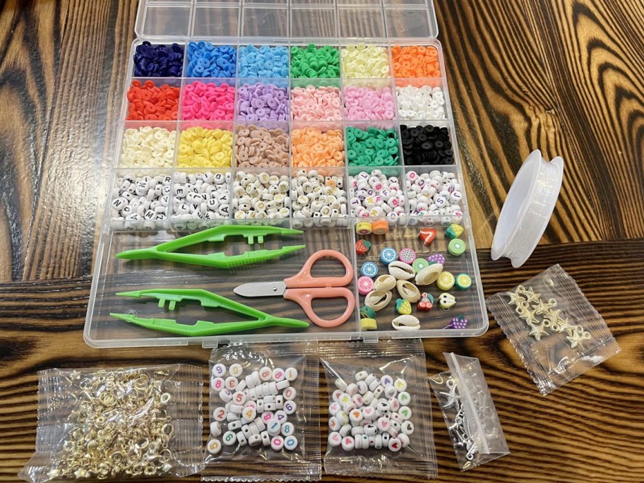 bead making kit on table in container with scissors, string and more on table