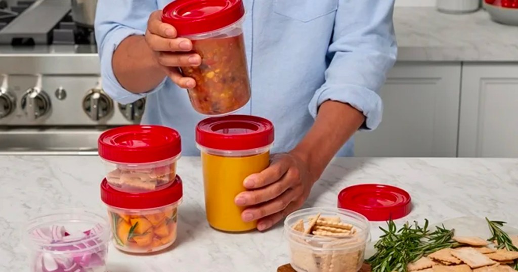 person stacking rubbermaid takealong food storage containers on counter