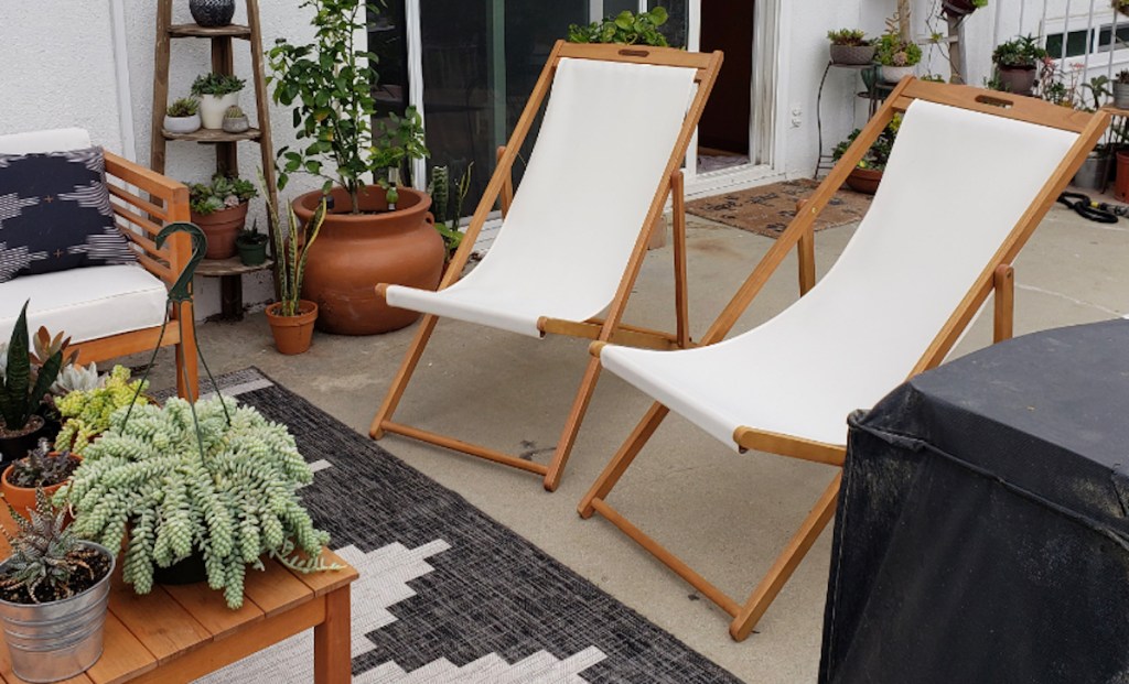 two white and wood beach sling chairs on outdoor patio