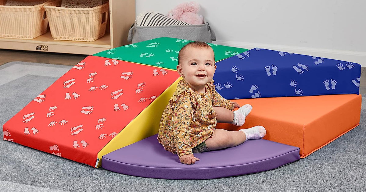 baby sitting on softzone climbing playset