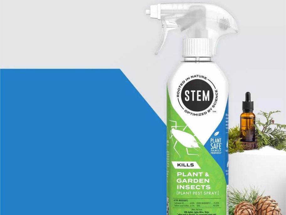 STEM 12oz Plant Spray next to essential oil bottle and pinecones with blue and white background