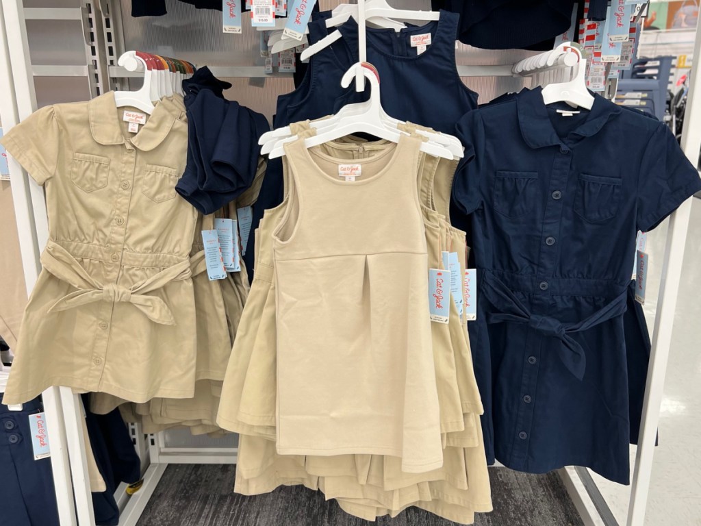 target display of girl uniform dresses and jumpers