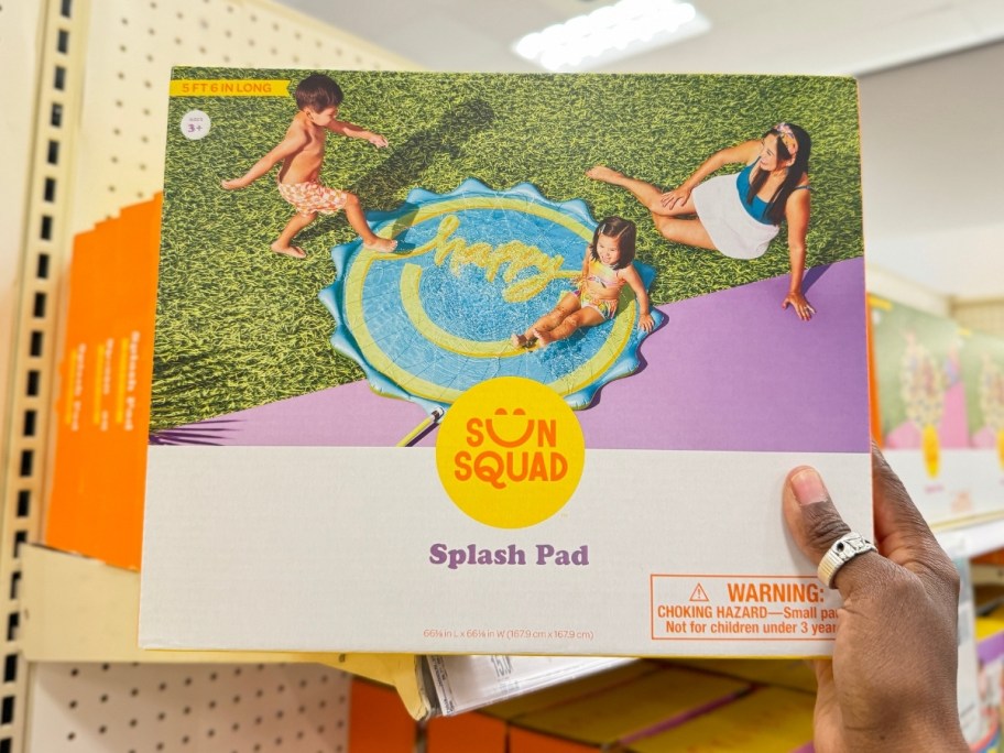 hand holding a box with a Splash Pad Play Sprinkler